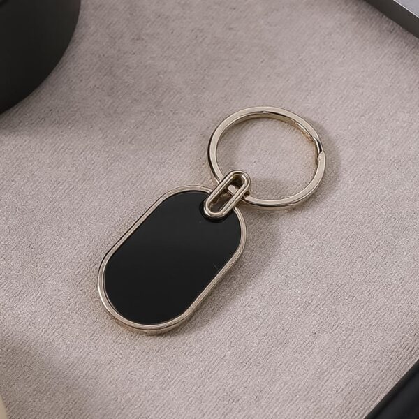 01_151642c1-1310-4b5a-921b-56460878c36f.jpg Elegant Black & Silver Oval Metal Keychain (1 Pc)