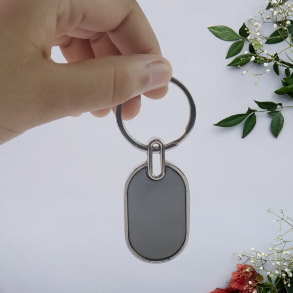 03_35260e64-74cb-4f1d-aecd-09c7ae14d613.jpg Elegant Black & Silver Oval Metal Keychain (1 Pc)