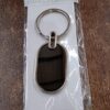 dadcbe02-ee5d-40ea-b15e-9ab9b67b4851.jpg Elegant Black & Silver Oval Metal Keychain (1 Pc)